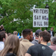 A group of protestors holds a sign while gathering in Montreal to oppose the controversial Bill 96.